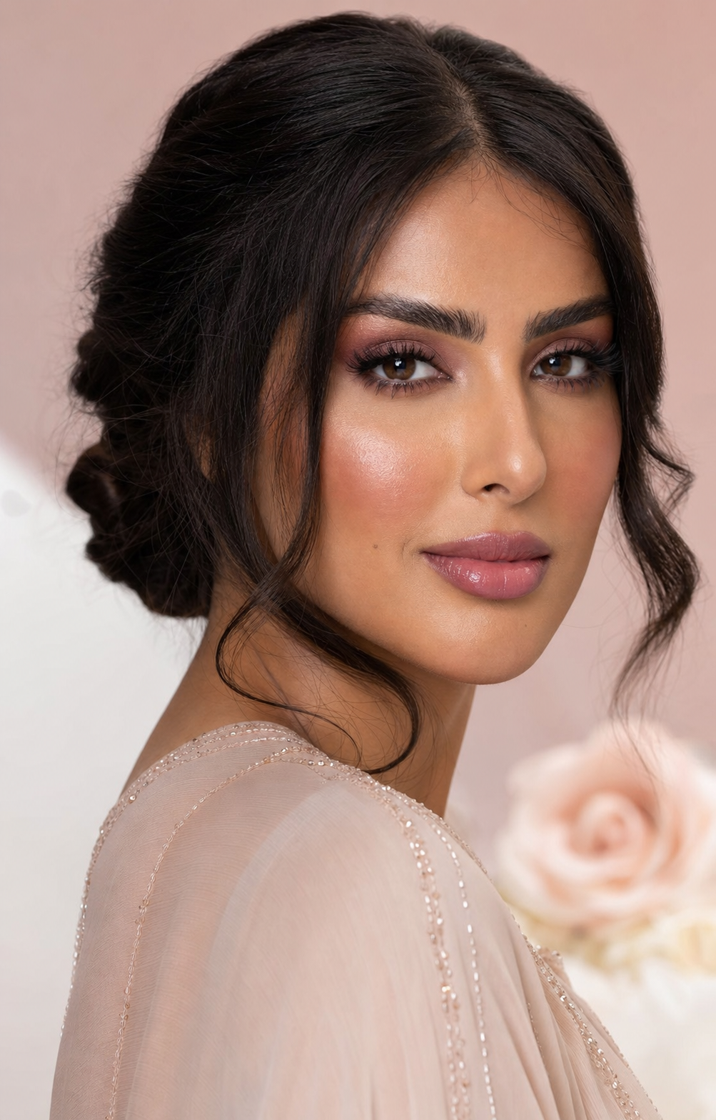 A Gulf Arab client wearing luminous rose and plum makeup